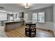 Open floor plan featuring kitchen island, adjacent to a dining area with wainscoting and hardwood floors at 3081 Frankie Ln, Duluth, GA 30096