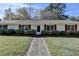 Close up of a ranch home with red shutters, tidy shrubs, and front door at 3081 Frankie Ln, Duluth, GA 30096