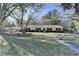 Charming ranch home with mature trees, red shutters, and lush lawn at 3081 Frankie Ln, Duluth, GA 30096
