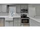 Stylish gray cabinets and countertops in updated kitchen at 3081 Frankie Ln, Duluth, GA 30096