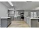 Modern kitchen with stainless steel appliances and gray cabinetry at 3081 Frankie Ln, Duluth, GA 30096