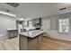 Kitchen with granite countertops, stainless appliances, gray cabinets, an island, and wood flooring at 3081 Frankie Ln, Duluth, GA 30096