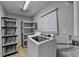 A bright laundry room with shelving and a large washing machine at 3081 Frankie Ln, Duluth, GA 30096