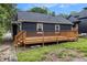 The backyard includes a wooden deck for entertaining with stairs leading to a lawn at 609 Spring St, Atlanta, GA 30354