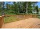 This backyard features a wooden deck, grass, and trees at 609 Spring St, Atlanta, GA 30354