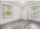 Bright bedroom with wood-look flooring, two windows and a closet at 609 Spring St, Atlanta, GA 30354