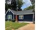 Charming home with a dark blue exterior, red door, and well-manicured lawn at 609 Spring St, Atlanta, GA 30354