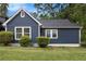 Charming blue home featuring manicured landscaping and bright white trim, adding to its curb appeal at 609 Spring St, Atlanta, GA 30354