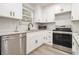 Modern kitchen with stainless appliances, granite countertops, and tile backsplash at 609 Spring St, Atlanta, GA 30354