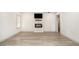 Bright living room features modern flooring, a fireplace with a TV, and fresh, white walls at 609 Spring St, Atlanta, GA 30354