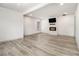 Bright, empty living room features modern flooring, a fireplace with a TV, and fresh, white walls at 609 Spring St, Atlanta, GA 30354
