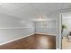 Finished basement area featuring neutral colors, drop ceiling, and dark wood flooring at 6332 Fairoaks Pl, Douglasville, GA 30135