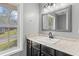 Bathroom sink features black fixtures and stylish vanity and overlooks a large picture window at 6332 Fairoaks Pl, Douglasville, GA 30135
