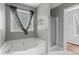 A modern bathroom with a large soaking tub, a walk-in shower, and stylish fixtures and fittings at 6332 Fairoaks Pl, Douglasville, GA 30135