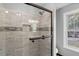 A luxurious bathroom showcases a glass shower door and stylish tile at 6332 Fairoaks Pl, Douglasville, GA 30135