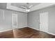 A bright bedroom features hardwood floors, a ceiling fan and overlooks an attached bathroom and walk-in closet at 6332 Fairoaks Pl, Douglasville, GA 30135