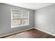 A cozy bedroom featuring a bright window with wood floors at 6332 Fairoaks Pl, Douglasville, GA 30135