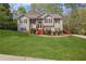 Beautiful two-story home with stone accents, a well-kept lawn, and mature landscaping at 6332 Fairoaks Pl, Douglasville, GA 30135