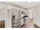 Stainless steel appliances, white cabinets, and hardwood floors highlight this modern kitchen at 6332 Fairoaks Pl, Douglasville, GA 30135
