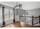 Second floor landing area featuring wood floors, a large window, and decorative chandelier at 6332 Fairoaks Pl, Douglasville, GA 30135