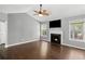 Bright living room with hardwood floors, fireplace, ceiling fan, and vaulted ceilings at 6332 Fairoaks Pl, Douglasville, GA 30135