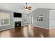 Living room with fireplace, ceiling fan and windows offering an abundance of natural light at 6332 Fairoaks Pl, Douglasville, GA 30135