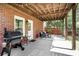 Covered back patio featuring a grill, seating area, and brick wall at 1257 Arkwright Se Pl, Atlanta, GA 30317