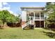 Large backyard with a patio, stairs, mature trees, and plenty of space for outdoor activities at 1257 Arkwright Se Pl, Atlanta, GA 30317