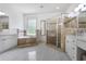 Large bathroom featuring double vanities, a soaking tub, and a separate glass-enclosed shower at 1257 Arkwright Se Pl, Atlanta, GA 30317