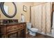 Bathroom featuring a decorative vanity, an ornate round mirror, and a shower with patterned curtain at 1257 Arkwright Se Pl, Atlanta, GA 30317