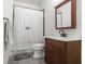 Traditional bathroom featuring a vanity with a wooden cabinet and a shower with a patterned curtain at 1257 Arkwright Se Pl, Atlanta, GA 30317