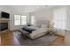 Spacious bedroom boasts a stone fireplace, large windows, a tufted bed, and stylish decor at 1257 Arkwright Se Pl, Atlanta, GA 30317