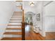 Inviting entryway with hardwood floors, staircase, and view to the kitchen at 1257 Arkwright Se Pl, Atlanta, GA 30317