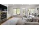 Comfortable living room with fireplace, built-in shelves, and access to an outdoor deck at 1257 Arkwright Se Pl, Atlanta, GA 30317