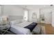 Bright main bedroom showcases a tufted headboard, hardwood floors, and an ensuite bathroom at 1257 Arkwright Se Pl, Atlanta, GA 30317