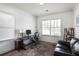 Functional office space with a desk, comfortable seating, and natural light streaming through the window at 1257 Arkwright Se Pl, Atlanta, GA 30317