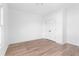 Spacious bedroom features light hardwood floors, neutral walls, a window, and double-door closet at 3322 Springhaven Ave, Hapeville, GA 30354