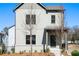 Beautiful two-story home with gray siding and brick foundation and a welcoming covered front porch at 3322 Springhaven Ave, Hapeville, GA 30354