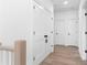 Bright hallway featuring neutral walls, modern doors with matte black hardware, and wide-plank floors at 3322 Springhaven Ave, Hapeville, GA 30354