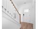 Inviting foyer with a staircase and modern front door, and stylish hardwood flooring at 3322 Springhaven Ave, Hapeville, GA 30354