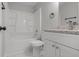 Well-lit bathroom with white cabinets, granite countertops, a tub shower, and modern fixtures at 425 Orchard Dr, Stone Mountain, GA 30083