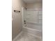 Clean white bathtub and shower combo with tile flooring at 425 Orchard Dr, Stone Mountain, GA 30083