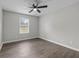 Minimalist bedroom featuring a large window, hardwood floors, and a bright, neutral color palette at 425 Orchard Dr, Stone Mountain, GA 30083