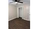 Bedroom features open closet, dark flooring and ceiling fan at 425 Orchard Dr, Stone Mountain, GA 30083