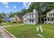 Exterior shot of a two-story home showcasing a front lawn in need of some TLC on a sunny day at 425 Orchard Dr, Stone Mountain, GA 30083