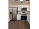 Updated kitchen features stainless steel appliances and white cabinets at 425 Orchard Dr, Stone Mountain, GA 30083