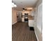 Modern kitchen with stainless steel appliances, white cabinets, and wood-look flooring at 425 Orchard Dr, Stone Mountain, GA 30083