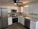 Bright kitchen boasts stainless steel appliances, granite countertops, and white cabinets at 425 Orchard Dr, Stone Mountain, GA 30083