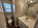 A bathroom featuring a vanity with a white countertop and mirror, along with a toilet and tub at 118 Dove Lndg, Social Circle, GA 30025