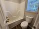 A bathroom showing a shower and tub with a toilet, and a window with blinds at 118 Dove Lndg, Social Circle, GA 30025